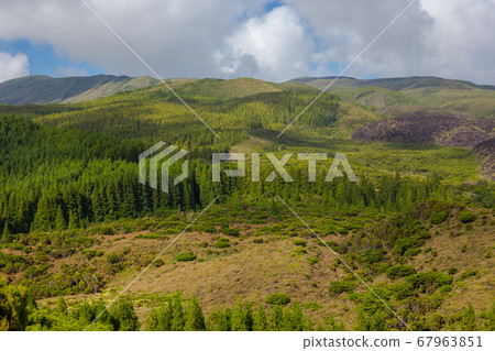 Hills over fields. Terceira island in Azores with blue sky and clouds. Hills over fields. Terceira island in Azores with blue sky and clouds. 67963851