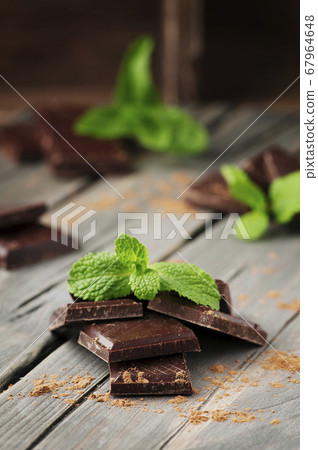 Dark chocolate with mint on the vintage table Dark chocolate with mint on the vintage table 67964648