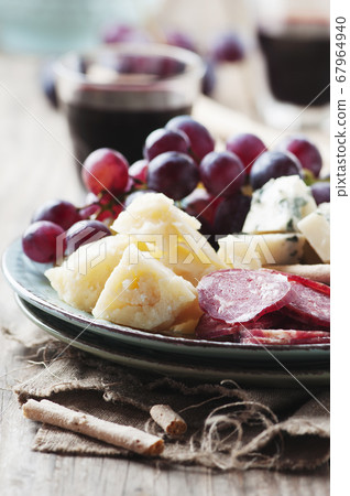 Antipasto with cheese, sausage and grape 67964940