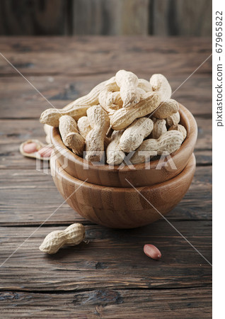 Paenut in the bowl in the wooden table Paenut in the bowl in the wooden table 67965822