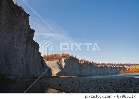 The rocky shores of the siberian taiga fall river The rocky shores of the siberian taiga fall river 67966117
