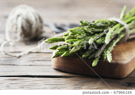 Fresh wild asparagus on the wooden table Fresh wild asparagus on the wooden table 67966184