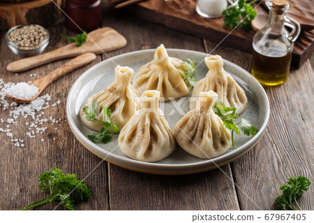 Georgian dumplings khinkali on the wooden table Georgian dumplings khinkali on the wooden table 67967405