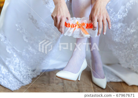 Garter on the leg of a bride, slim sexy bride in Garter on the leg of a bride, slim sexy bride in 67967671