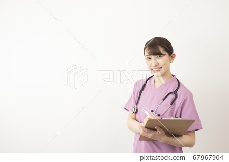 Female pharmacist with clipboard wearing scrubs 67967904