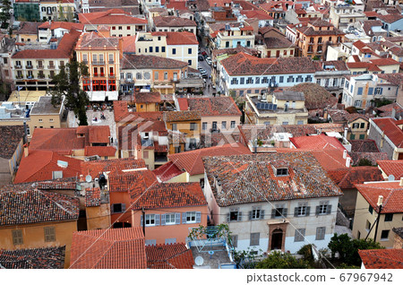 Looking down over Nafplio with a view of the roofs of the pretty houses. Nafplio is an old town in Peloponnese Greece with historic roots. Nafplio is also known as Nafplion, Nauplio and Nauplion. 67967942