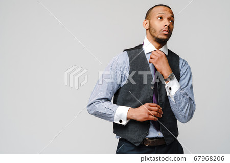 Young adult afro american businessman with tired and sick expression studio shot Young adult afro american businessman with tired and sick expression studio shot 67968206