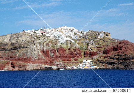 Oia, Santorini, Greece. A view of Santorini from the sea arriving on a ship. Santorini is a Greek island with pretty white houses on the clifftop. Oia, Santorini, Greece ,sea view, cliff, white houses 67968614