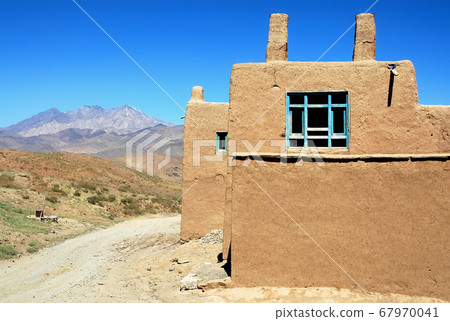 Village between Kabul and Bamyan (Bamiyan) in Afghanistan. A local home in a small village on the southern route between Kabul and Bamyan (Bamiyan). House, dwelling, road, scenery, central Afghanistan Village between Kabul and Bamyan (Bamiyan) in Afghanistan. A local home in a small village on the southern route between Kabul and Bamyan (Bamiyan). House, dwelling, road, scenery, central Afghanistan 67970041