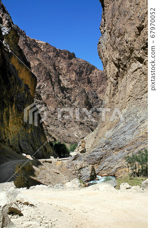The road passes through a narrow, rocky gorge between Kabul and Bamyan (Bamiyan) in Afghanistan. Taken from the road on the southern route between Kabul and Bamyan (Bamiyan) in central Afghanistan. The road passes through a narrow, rocky gorge between Kabul and Bamyan (Bamiyan) in Afghanistan. Taken from the road on the southern route between Kabul and Bamyan (Bamiyan) in central Afghanistan. 67970052