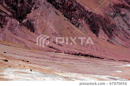 Red, magenta mountain scenery in the Kalu Valley between Kabul and Bamyan (Bamiyan), Afghanistan. Taken from the road on the southern route between Kabul and Bamyan (Bamiyan) in central Afghanistan. Red, magenta mountain scenery in the Kalu Valley between Kabul and Bamyan (Bamiyan), Afghanistan. Taken from the road on the southern route between Kabul and Bamyan (Bamiyan) in central Afghanistan. 67970058