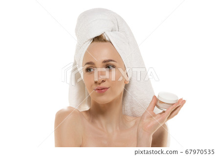 Beauty Day. Woman wearing towel doing her daily skincare routine. Portrait isolated on white studio background Beauty Day. Woman wearing towel doing her daily skincare routine. Portrait isolated on white studio background 67970535