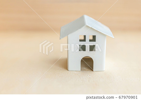 Miniature toy model house on wooden backdrop. Eco Miniature toy model house on wooden backdrop. Eco 67970901