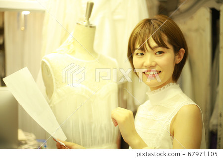 Woman making clothes 67971105