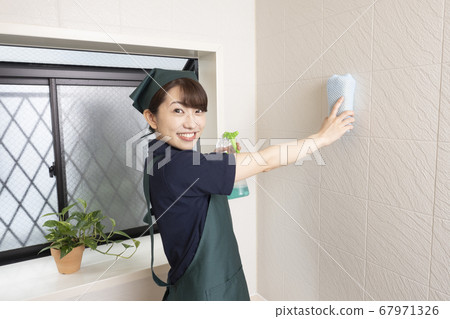 Female worker cleaning the house to clean the bathroom 67971326