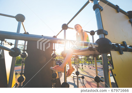 girl at the  large beautiful playground in the 67971666