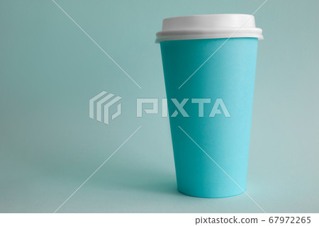 There is turquoise glass of coffee on table There is turquoise glass of coffee on table 67972265