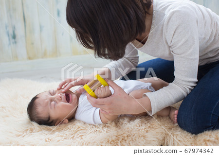 woman cradling a baby 67974342