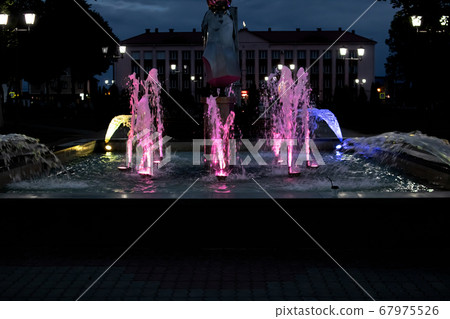 Colored lighting in the fountain at night Colored lighting in the fountain at night 67975526