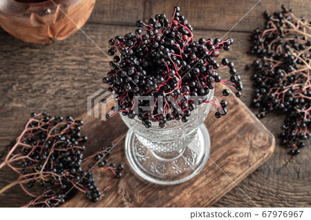 Black elder berries in a glass cup 67976967