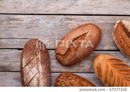 Natural organic bread assortment on wooden background. Natural organic bread assortment on wooden background. 67977208