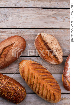 Bread on rustic wooden background. Bread on rustic wooden background. 67977209