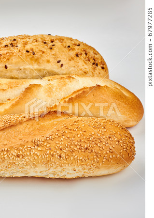 Three different baguettes on white background. 67977285