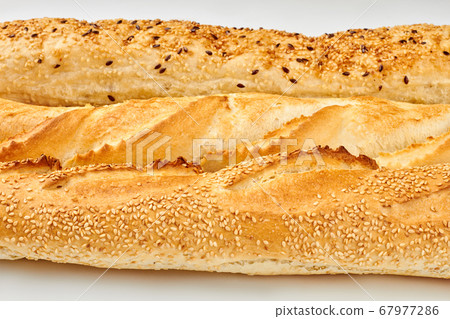 Close up of crusty baguettes with sesame and flax seeds. Close up of crusty baguettes with sesame and flax seeds. 67977286