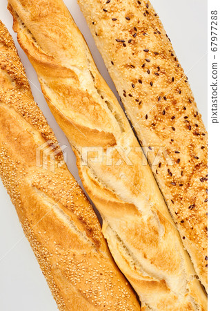 Three baguettes on white background. Three baguettes on white background. 67977288