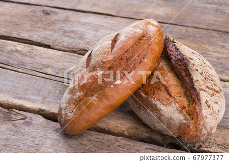 Traditional wheat bread on wooden background. Traditional wheat bread on wooden background. 67977377