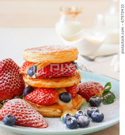 Mille Feuille with Lemon Curd, puff pastry discs with strawberries and blueberries with lemon curd. Mille Feuille with Lemon Curd, puff pastry discs with strawberries and blueberries with lemon curd. 67978410