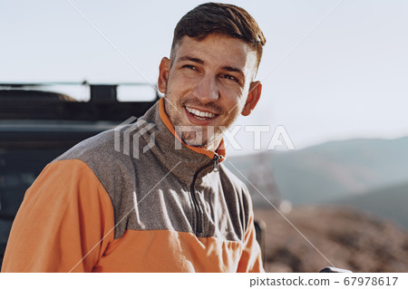 Portrait of a young caucasian man hiking in the mountains 67978617