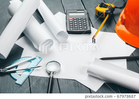 Engineer workplace with blueprints, compass, pencil and safety helmet. creative photo. Engineer workplace with blueprints, compass, pencil and safety helmet. creative photo. 67978687