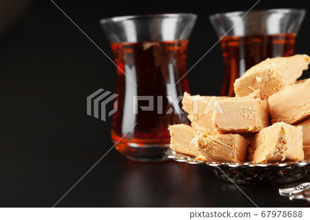Bowl with pieces of turkish delight lokum and black tea Bowl with pieces of turkish delight lokum and black tea 67978688