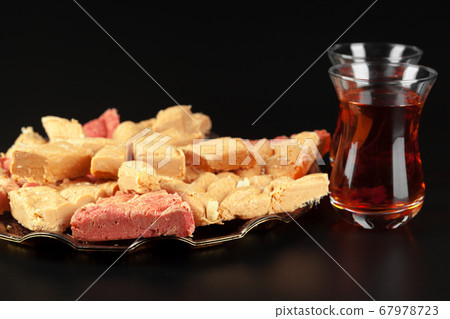 Bowl with pieces of turkish delight lokum and black tea Bowl with pieces of turkish delight lokum and black tea 67978723