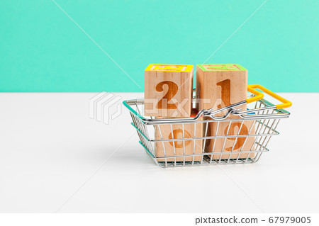year 2019 with shopping cart trolley on a white table year 2019 with shopping cart trolley on a white table 67979005