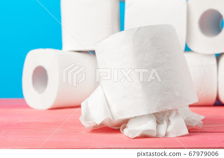 Toilet paper rolls stacked against blue background Toilet paper rolls stacked against blue background 67979006
