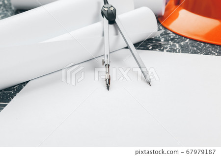 Engineer workplace with blueprints, compass, pencil and safety helmet. creative photo. Engineer workplace with blueprints, compass, pencil and safety helmet. creative photo. 67979187