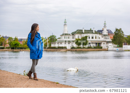 Woman walking in city park relaxing on weekend. Person enjoying lake view in Copenhagen, Denmark. Spring lifestyle activity, people outside. Woman walking in city park relaxing on weekend. Person enjoying lake view in Copenhagen, Denmark. Spring lifestyle activity, people outside. 67981121