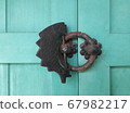 The fish-shaped lock hanging on the old building is pretty. 67982217