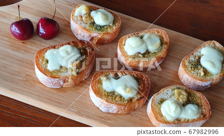 Grilled basil baguette on wooden cutting board 67982996