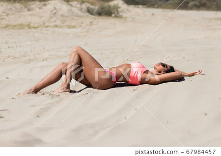 Stylish woman resting on beach 67984457