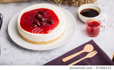 Ice box cheese cake with strawberry jam and a cup 67986232