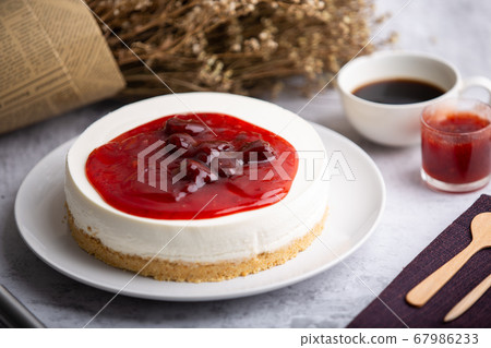 Ice box cheese cake with strawberry jam and a cup Ice box cheese cake with strawberry jam and a cup 67986233