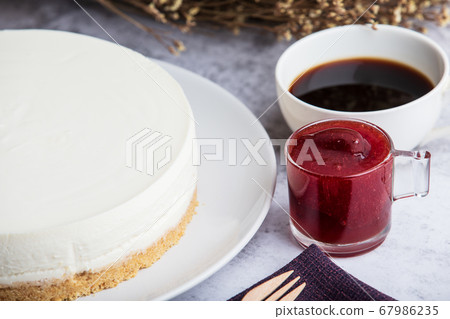 Ice box cheese cake with strawberry jam and a cup 67986235