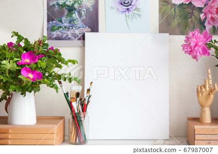 Empty workplace of woman artist next to materials for drawing brushes 67987007