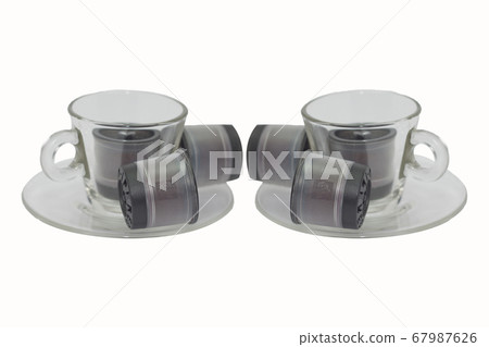 transparent cups with saucer and coffee pods 67987626