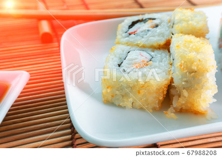Sushi with chopsticks, soy sauce, rustic wood Sushi with chopsticks, soy sauce, rustic wood 67988208