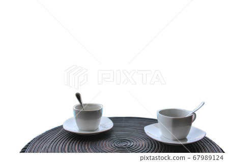 Two empty coffee cups with a spoon on the table Two empty coffee cups with a spoon on the table 67989124