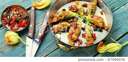 Fried zucchini flowers with filling. Fried zucchini flowers with filling. 67990036